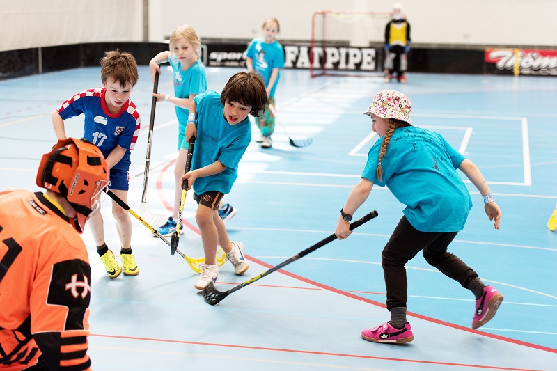Kinder beim Unihockey spielen